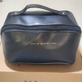 Dark blue cosmetic bag with top handle and front zipper, logo centered on front