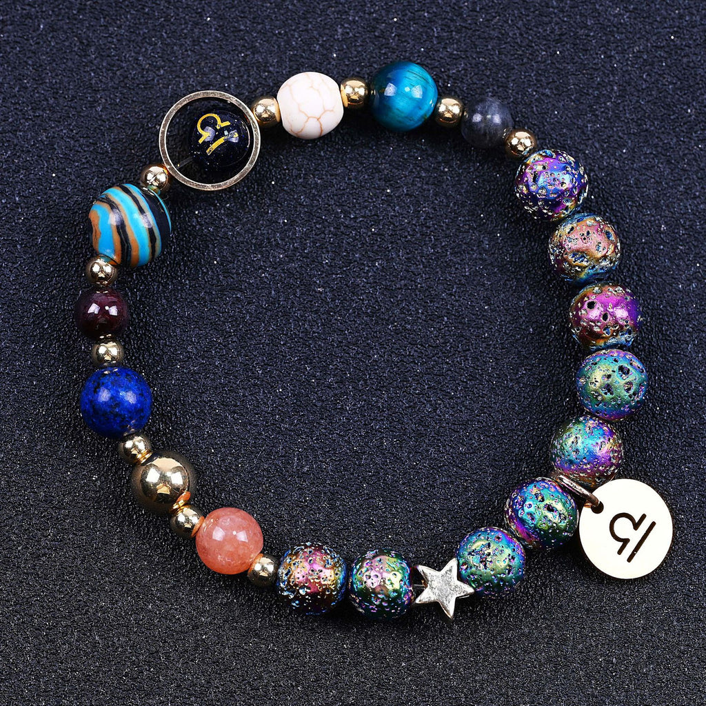 Beaded bracelet with blue stones, striped bead, rainbow speckled beads, star charm, zodiac disc.