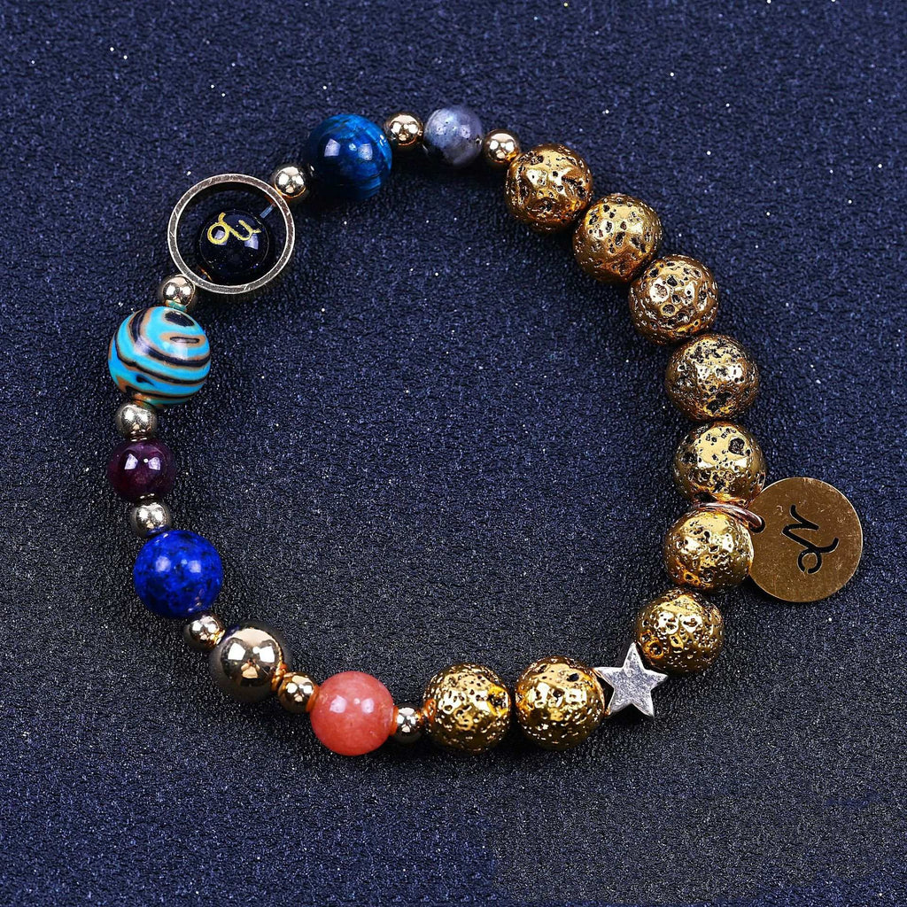 Beaded bracelet with blue, red, and gold beads; round zodiac charm and star detail.