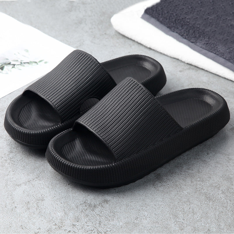 Black slide slippers with textured wide straps and cushioned sole