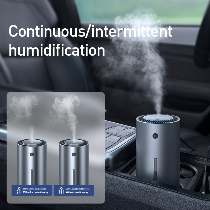 Silver-gray car humidifier diffuser producing mist from top nozzle