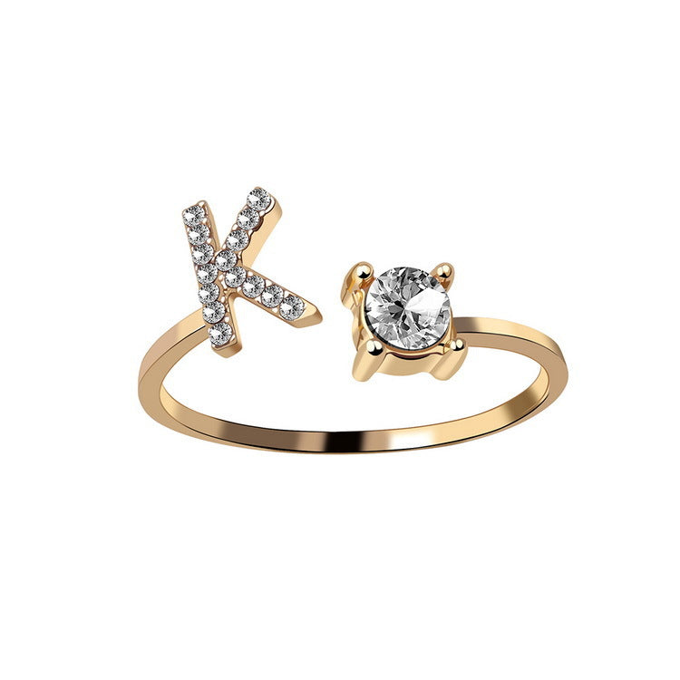 Adjustable initial letter ring with crystal letter detail and round center stone, gold-tone