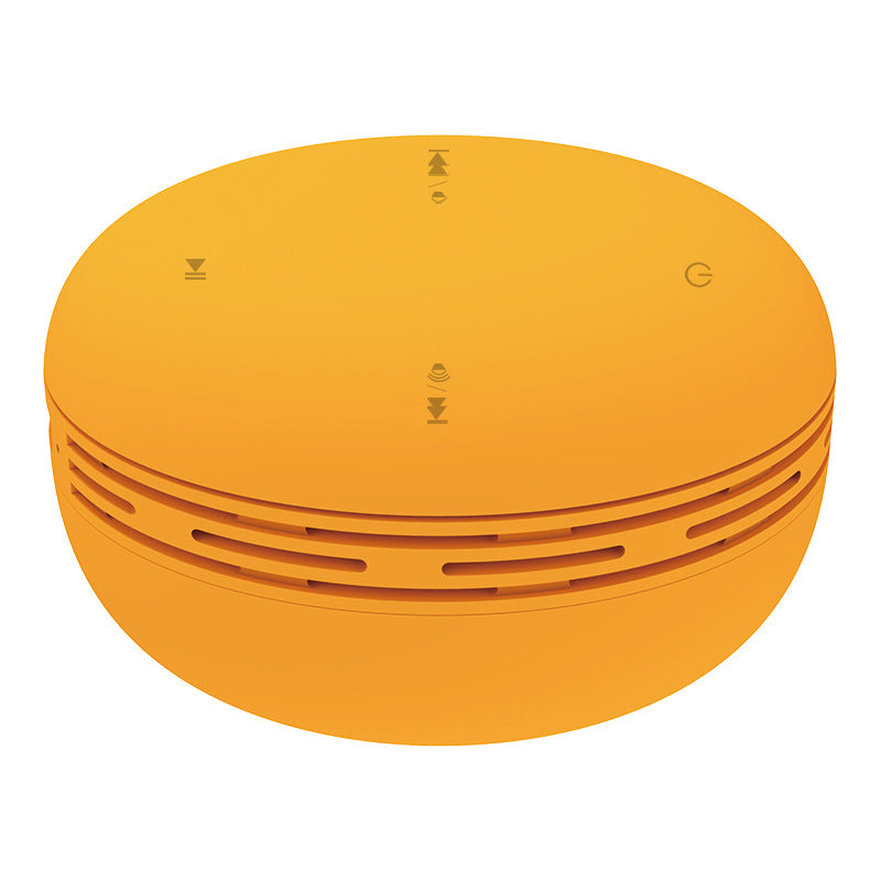 Orange mini Bluetooth speaker with top control icons and side grille vents