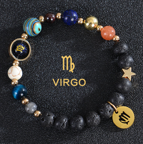Zodiac bracelet with black lava beads and Virgo charm, gold-tone spacers.
