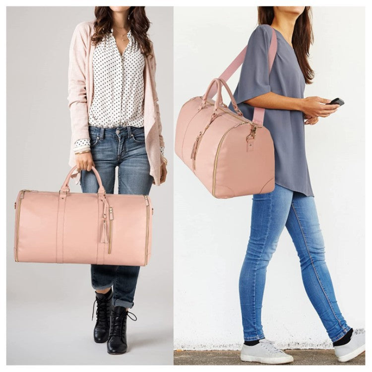 Light pink travel duffle bag worn over shoulder with structured handles and side zipper