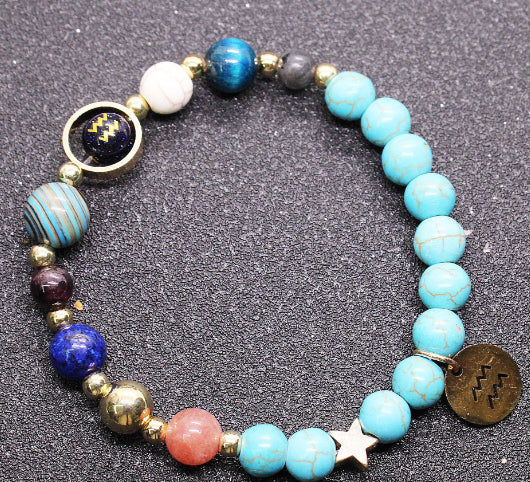 Beaded bracelet with turquoise & blue beads, gold-tone beads, zodiac charm disks