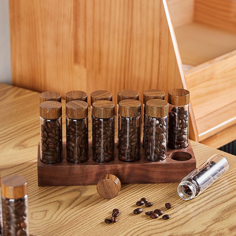Wooden glass bottle display rack with clear bean bottles and wooden caps