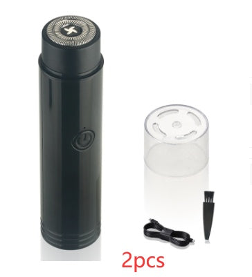 Black portable electric mini shaver with spare head, charging plug, and cable.