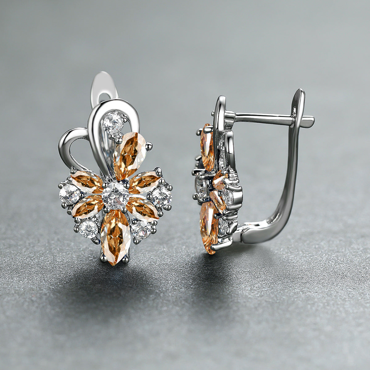 Flower drop-shaped zircon earrings with orange and clear stones in silver-tone settings