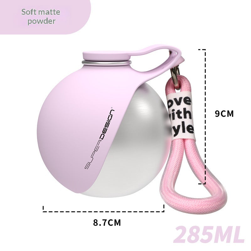 Soft mist pink stainless steel pet water bottle with carry handle and pink strap, close view.