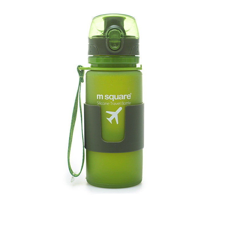 Green silicone travel water bottle with carry strap and flip-up drinking spout