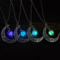 Silver crescent moon pendant necklace with glowing purple, blue, teal, and green stones