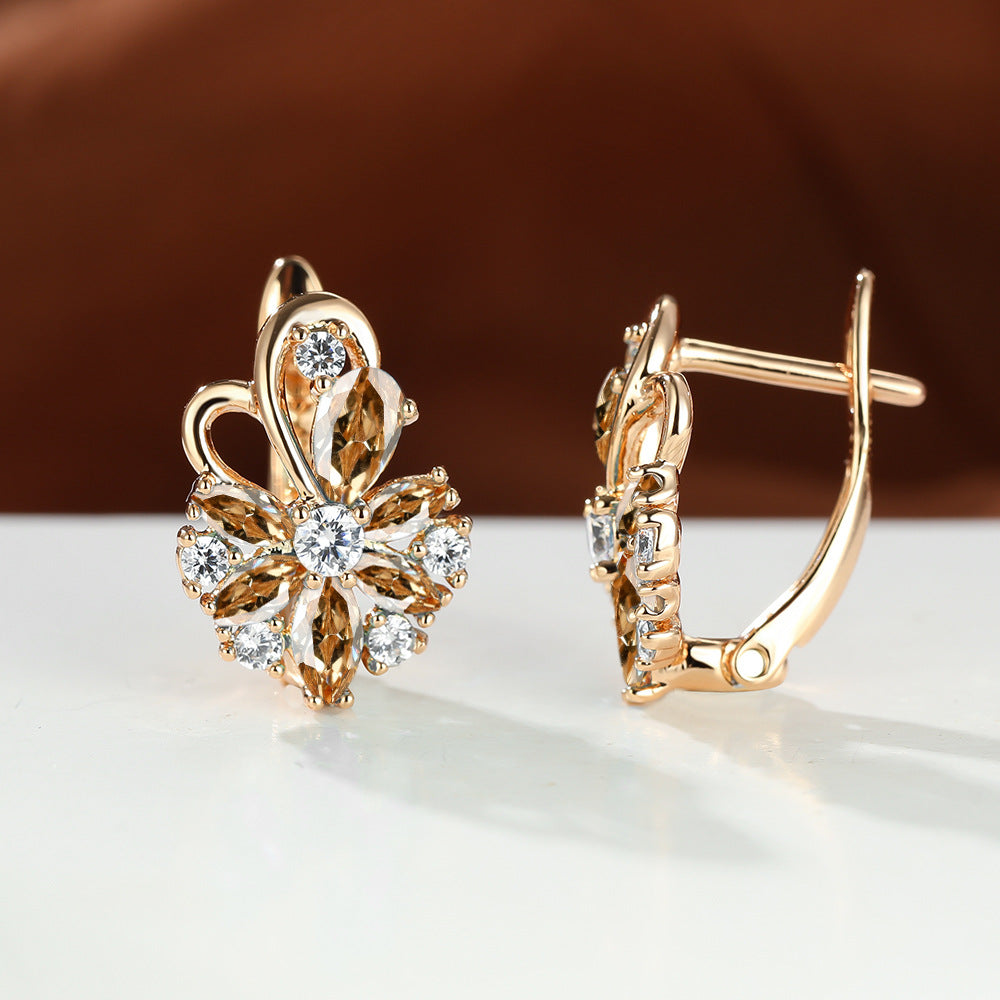 Gold-tone drop earrings with champagne/gold pear stones and clear round accents