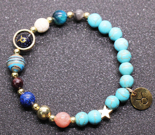 Beaded bracelet with turquoise & blue beads, gold-tone star spacer, zodiac charm disk