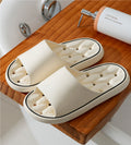 Off-white open-toe slide slippers with thick sole and molded cushioned footbed.