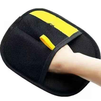 Pet hair removal glove pad held in hand, black with yellow striped insert