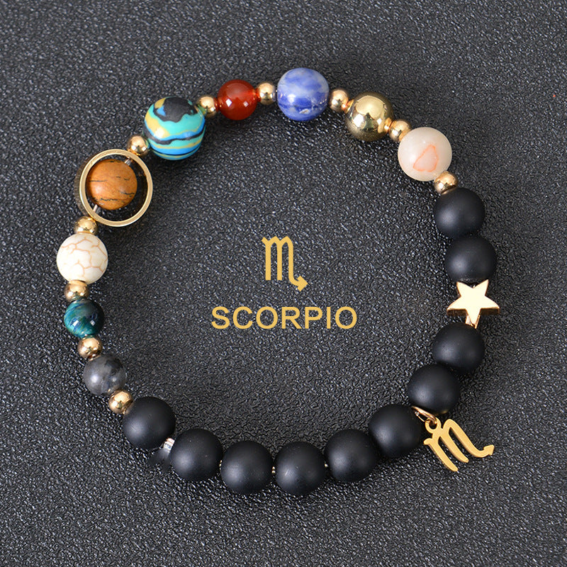 Scorpio zodiac beaded bracelet with black lava stones, star charm, and gold charm
