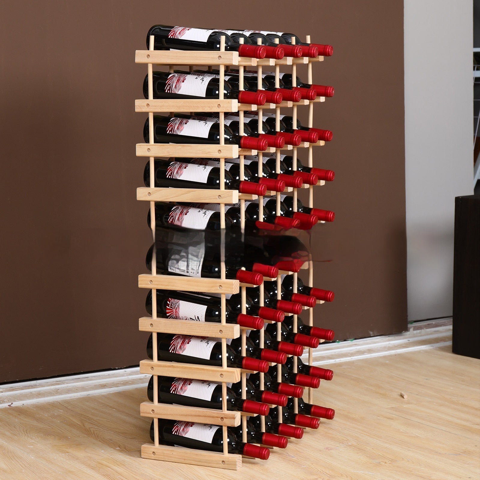 Wood wine rack with multiple bottle slots holding red wine bottles